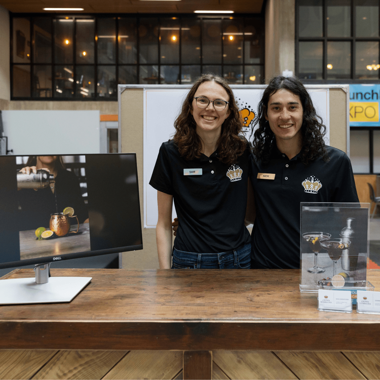 Two individuals behind booth at LaunchLab Expo Event