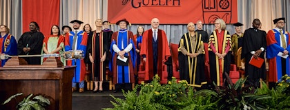 university executives standing on stage at convocation
