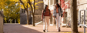two oac students walking near johnston hall in the fall