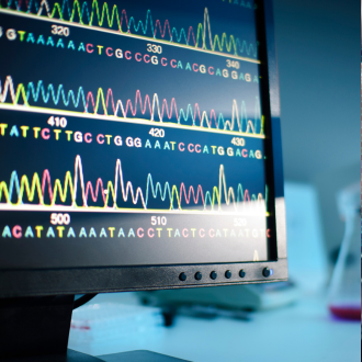 A computer monitor with a DNA sequence pattern on the screen.