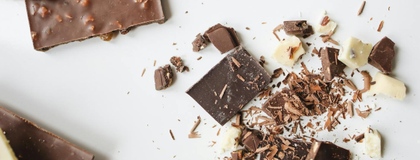 chocolate on a white table top, broken into pieces