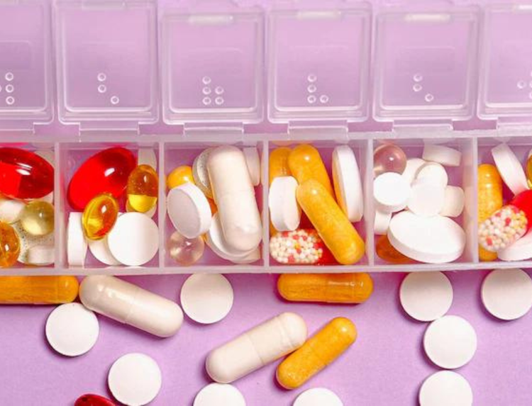 Various kinds pills inside a pill organizer.