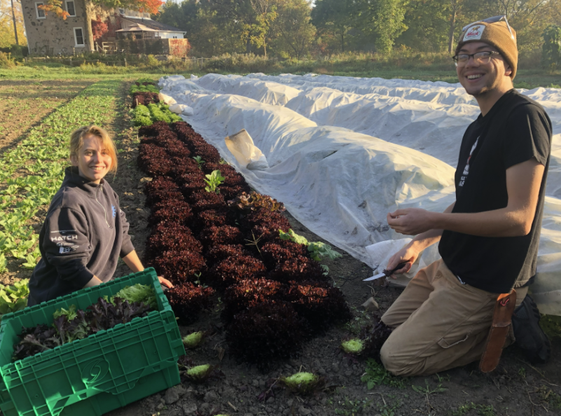 two people outside of the organic farm