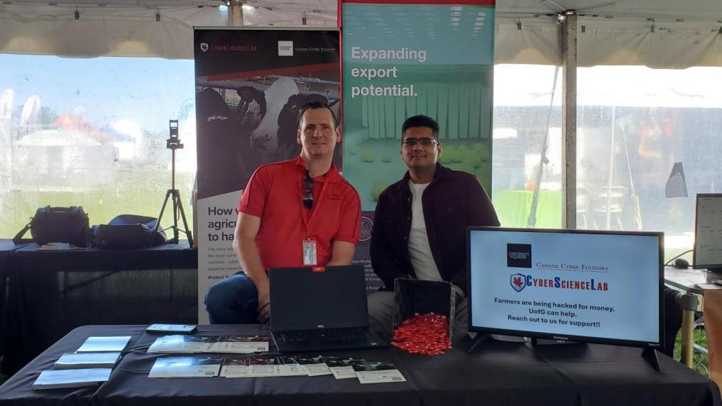 Two cyber security experts await questions in the Alliance booth at Canada's Outdoor Farm show