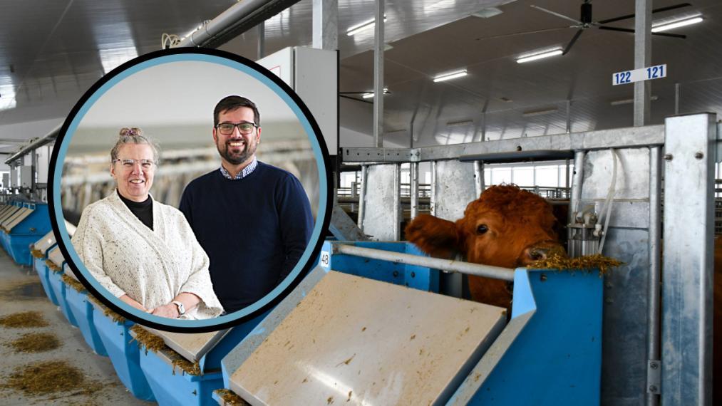 A beef cow eating from an automated feed bin, which has a metal flap, overlaid with a photo of Dr. Michelle Edwards and Dr. Lucas Alcantara, both smiling