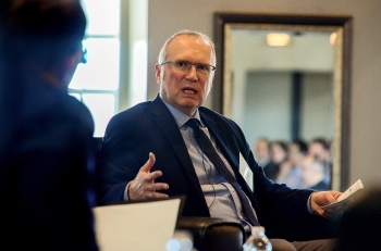 Greg Wootton gestures for emphasis as he speaks, seated as part of panel discussion