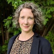 Jill Davies smiles in an outdoor headshot