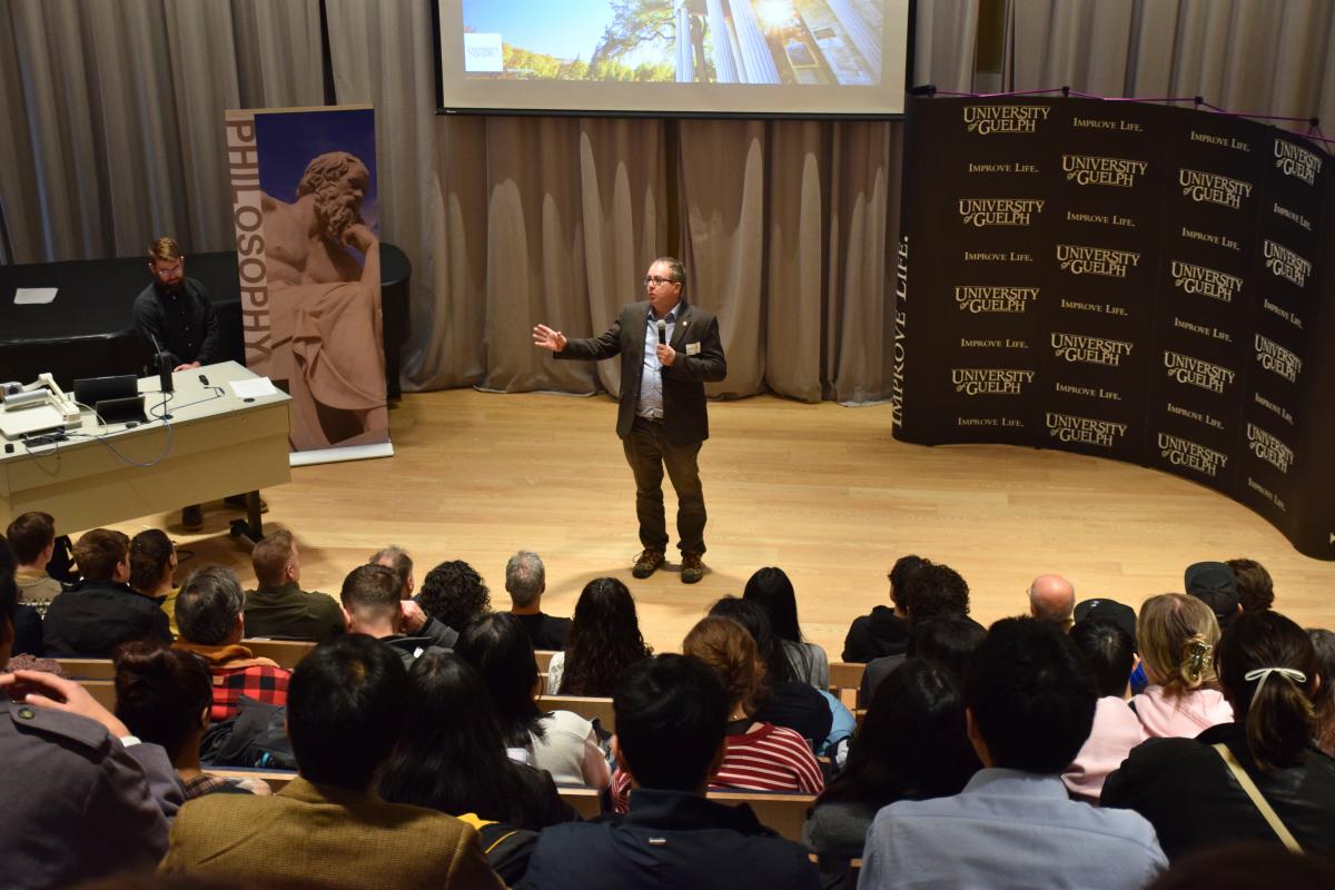 Dr. Andrew Bailey, acting dean, College of Arts, speaks to attendees at the Second Annual Guelph Regional High School Ethics Bowl in the auditorium in the College of Arts in the MacKinnon Building at the University of Guelph on February 8, 2025.