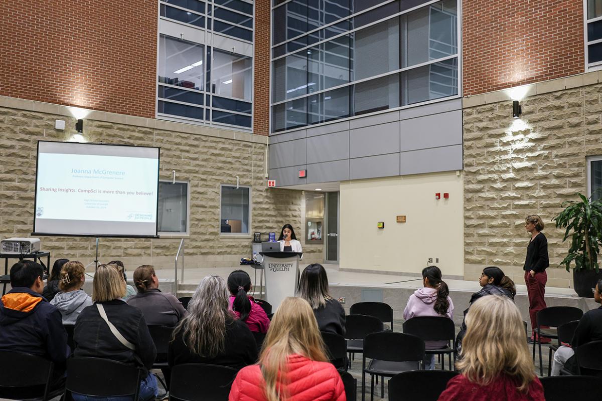 Sukhman Kaur speaking in front of high school students and U of G community at the Waasamowin Atrium.