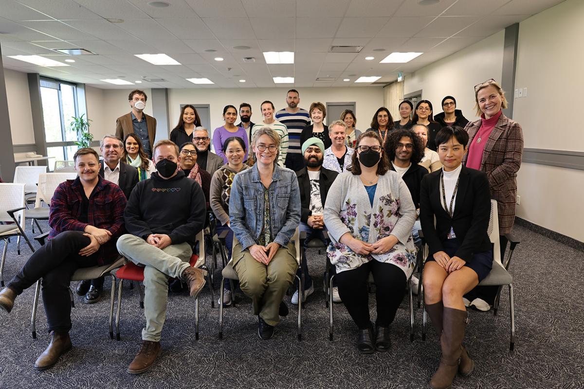 Group photo of panel speakers and attendees at the final Tremaine Speaker Series talk.