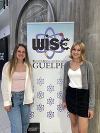 Laine Young and Jacqueline Zenobio standing next to the WiSE banner.