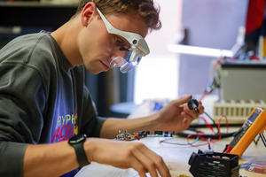 University of Guelph student preparing motors for Gryphon Racing's race cars.