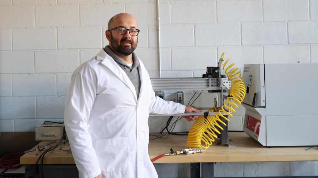 Dr. Alexander Bardelcik standing next to the furnace.