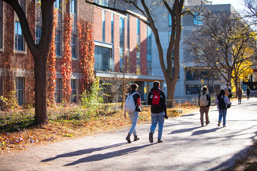 Albert A. Thornbrough Building in the fall with students walking in front. 