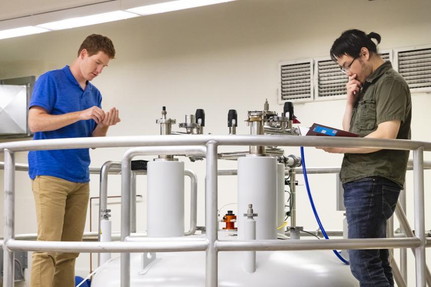 Two biophysics graduate students work together in U of G's NMR facility.