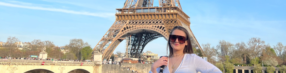 Student in front of the Eiffle Tower, Paris, France