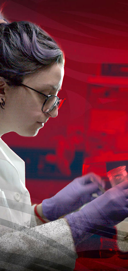 Woman in white lab coat holding a beaker