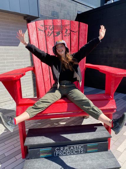 Madeline Landell sitting on a muskoka chair at the football stadium