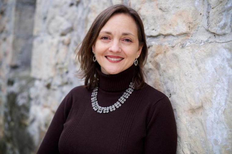 Justine Richardson in front of a stone wall