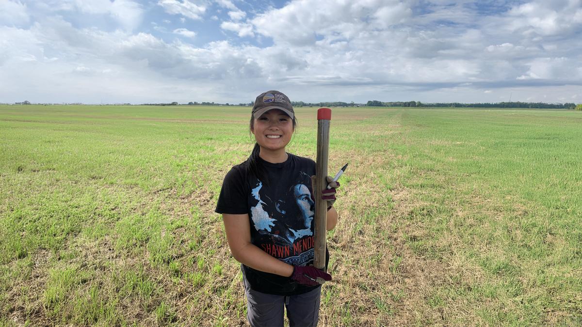 Skye Earley smiling while standing in a field. 