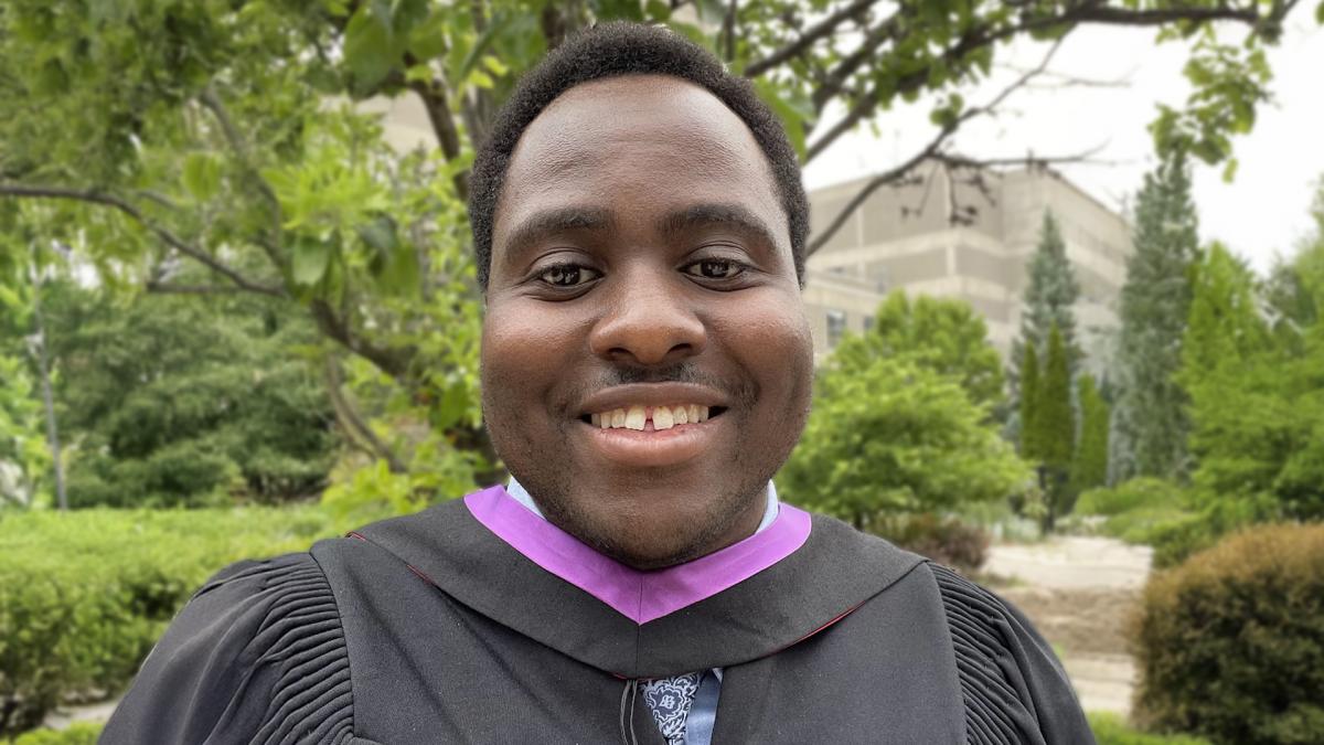 Stephen Sumary smiling in a graduation gown. 