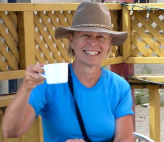 woman smiles with coffee cup