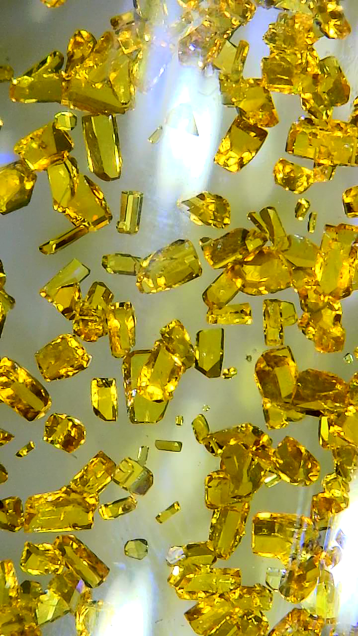 A microscopic view of yellow crystals,