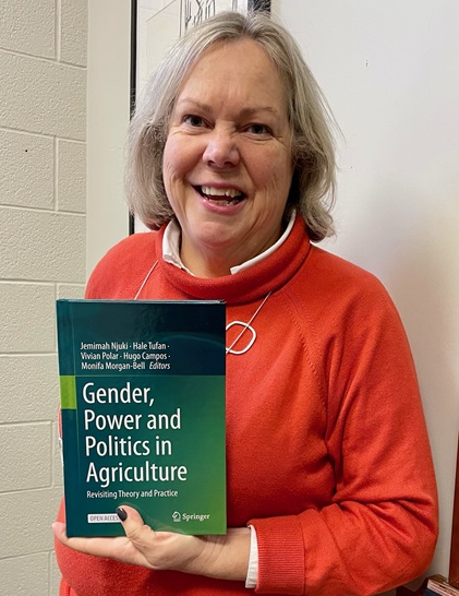 Helen Hambly posing with new book